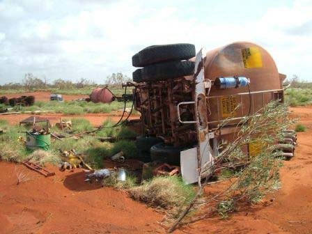 Overturned road tanker on a dusty Pilbara road after Cyclone George